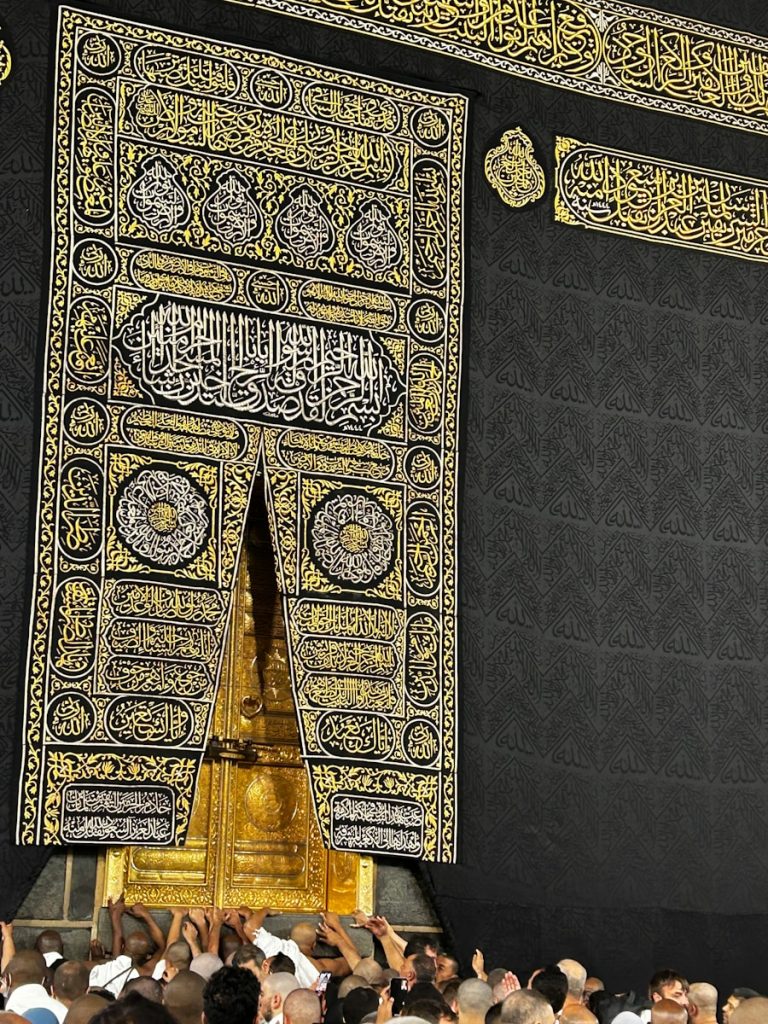 A group of people standing around a large building